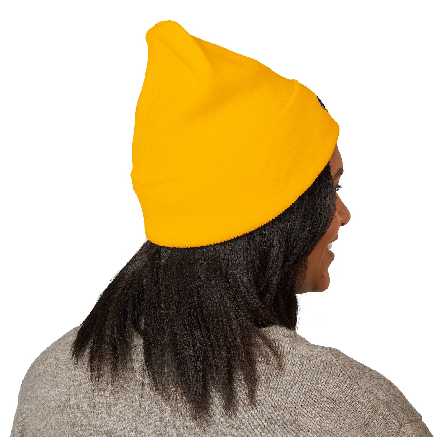 Person wearing a yellow beanie on a white background