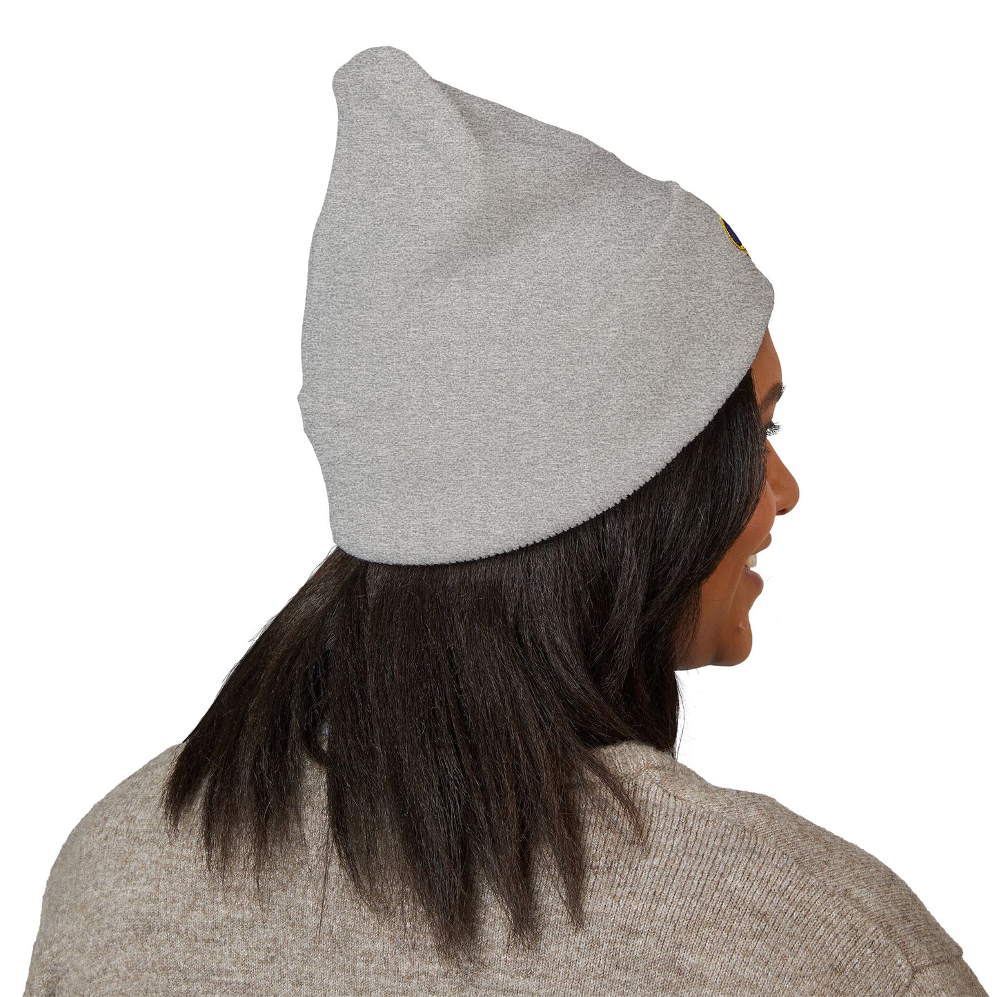 Person wearing a gray beanie on a white background lsu paw print logo