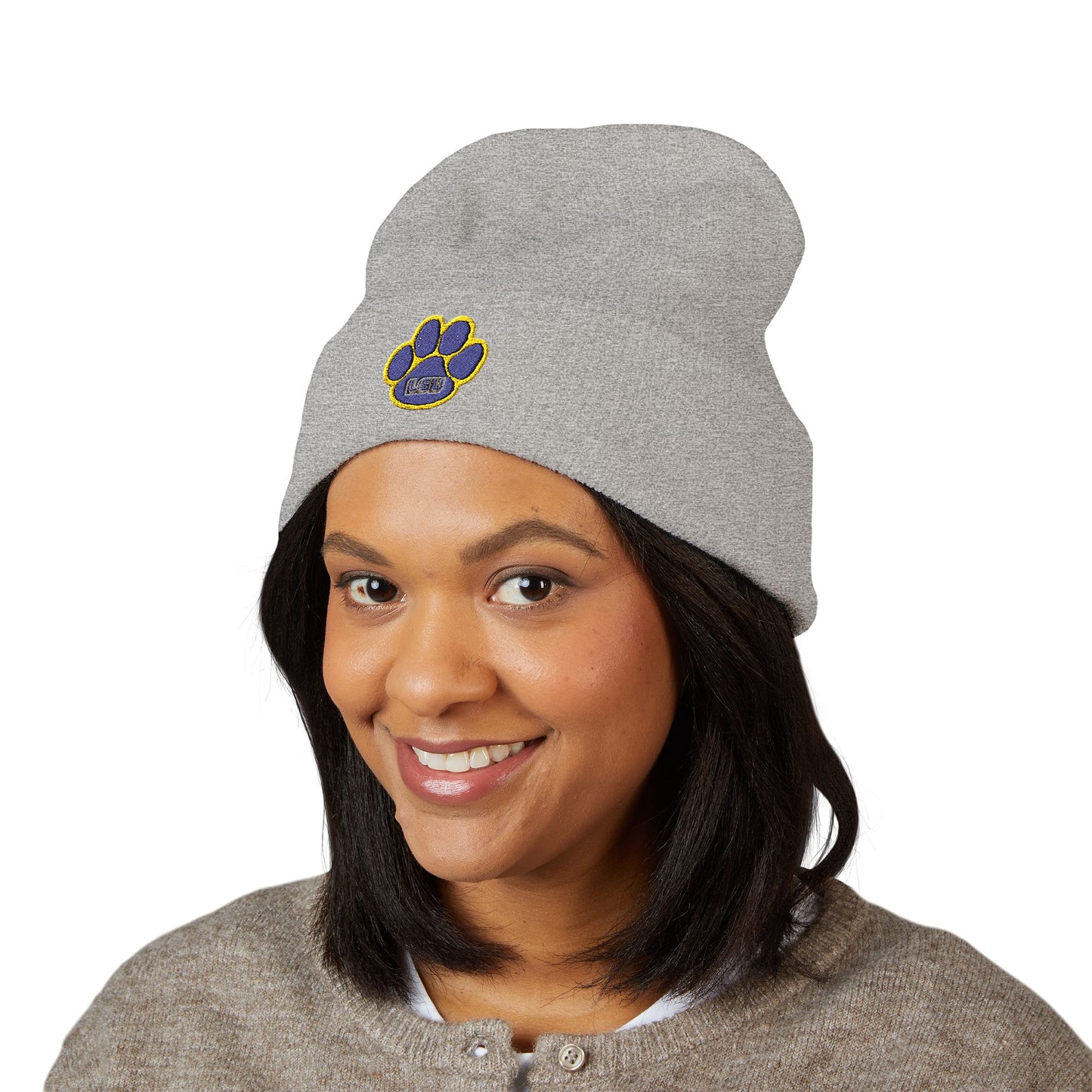 Person wearing a gray beanie with a paw print logo on a white background