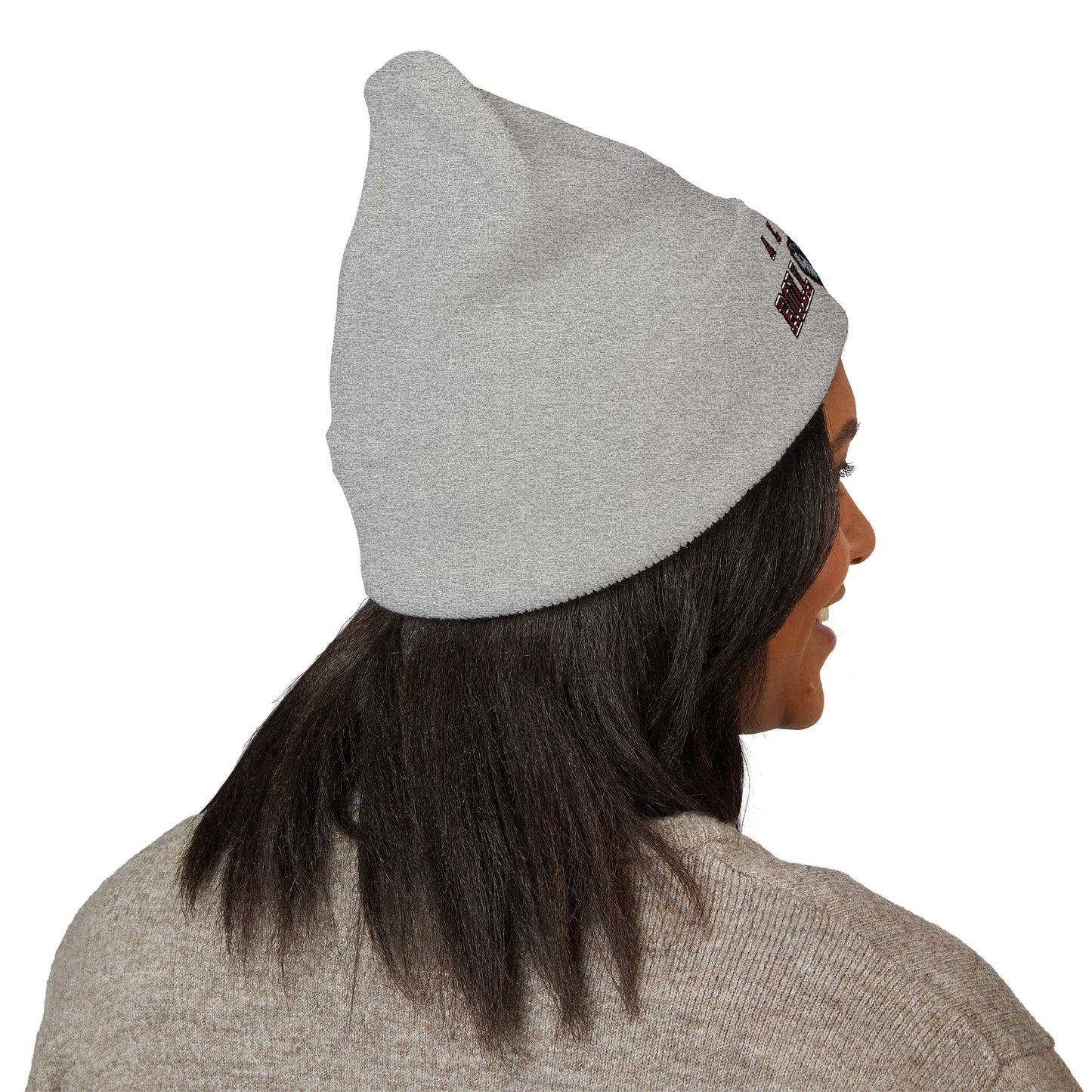 Person wearing a gray beanie with a logo on a white background with a alabama roll tide logo
