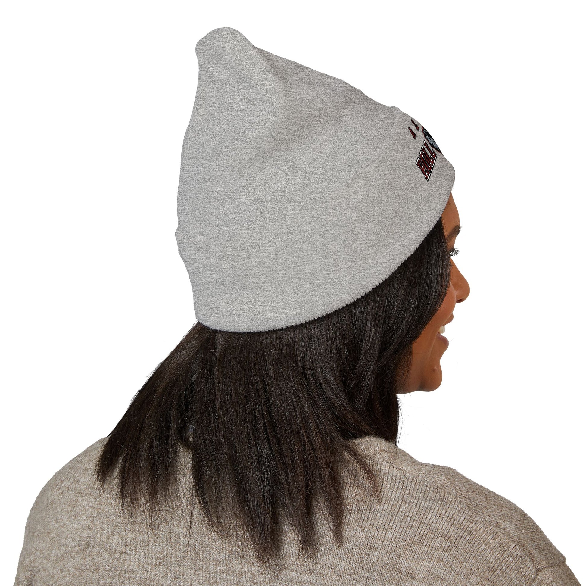 Person wearing a gray beanie with a logo on a white background with a alabama roll tide logo