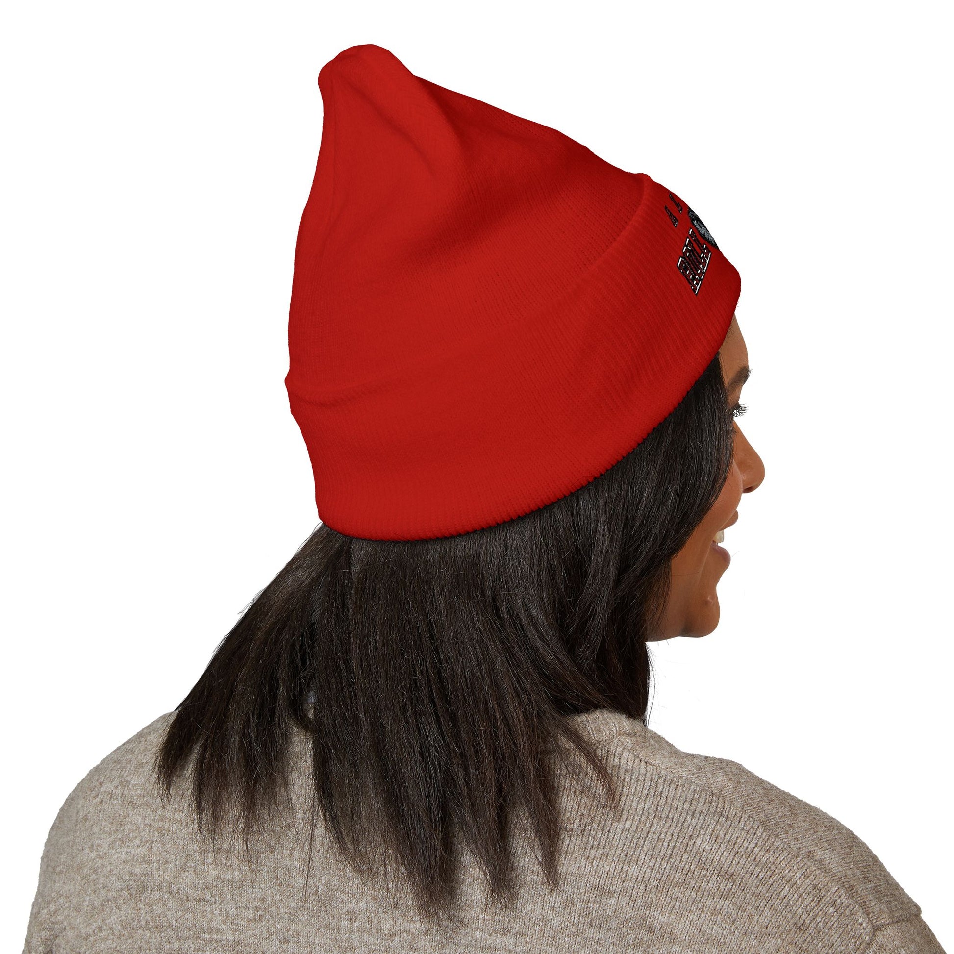 Person wearing a red beanie with a alabama roll tide brand logo on beanie on a white background
