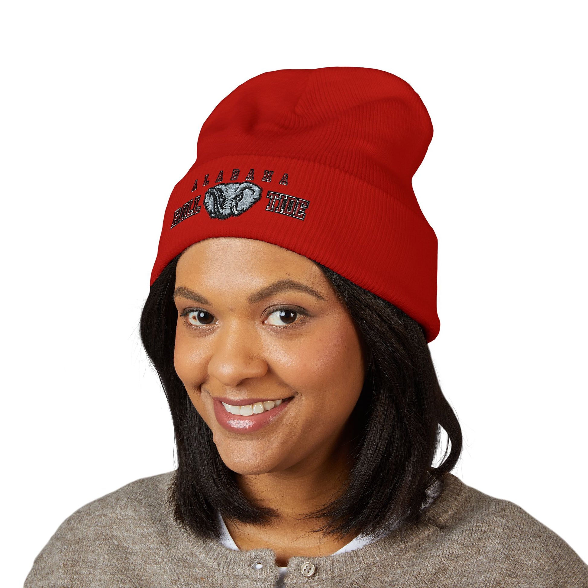 Person wearing a red beanie with a alabama roll tide logo on a white background