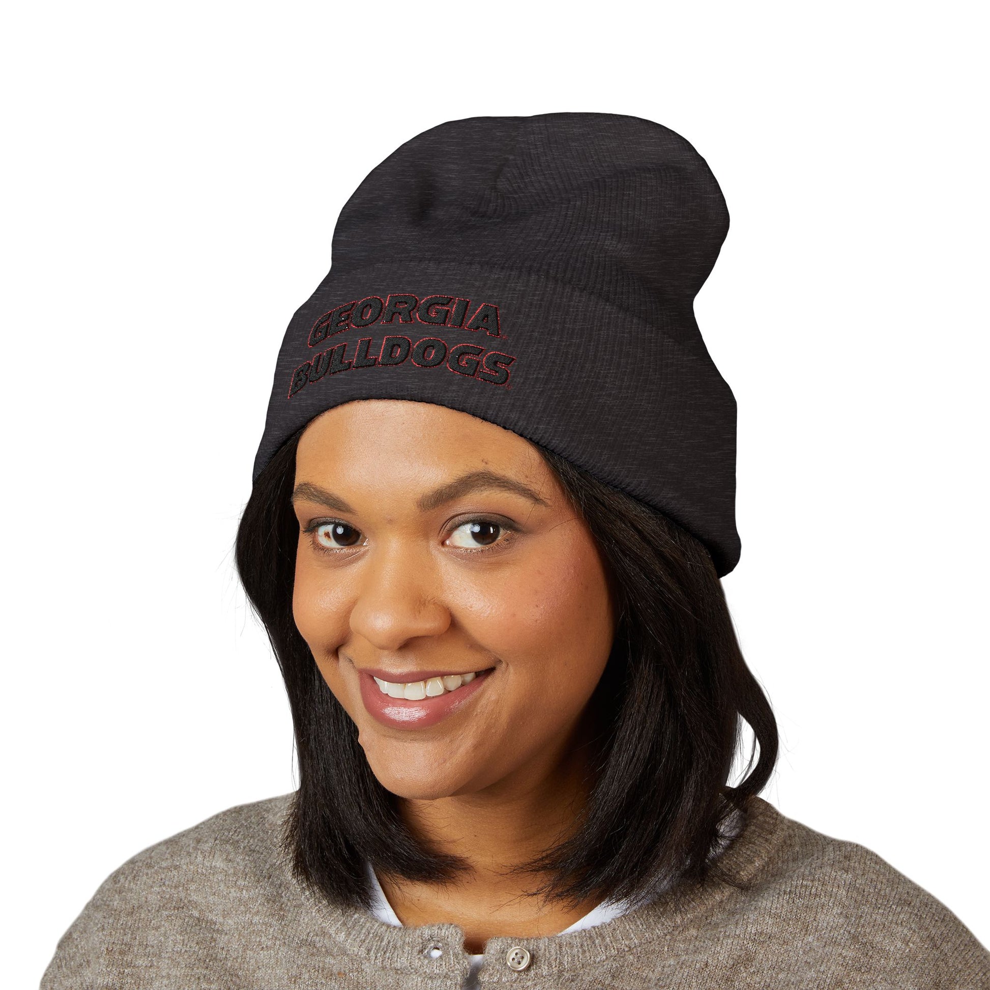 Person wearing a black 'Georgia Bulldogs' beanie on a white background