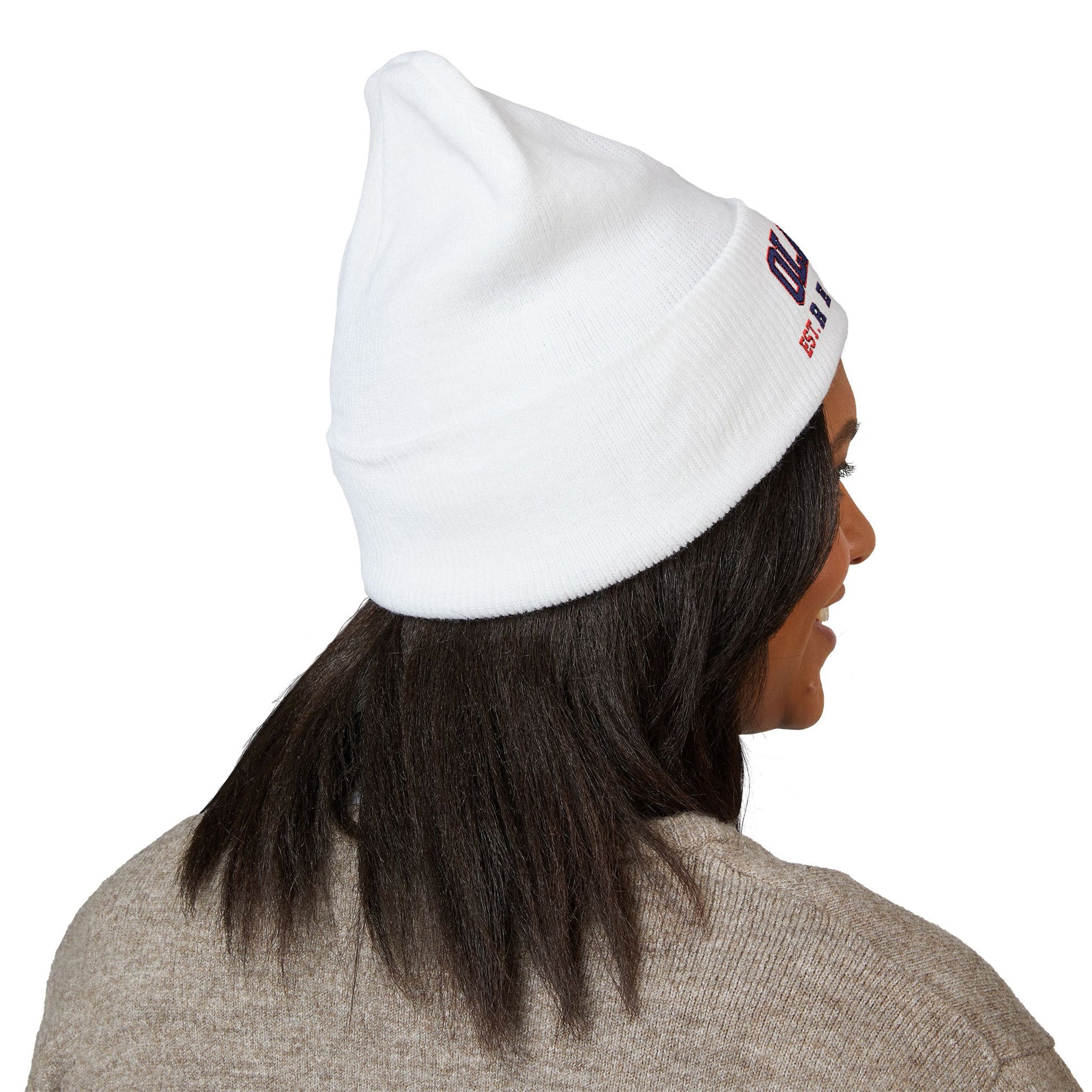 Person wearing a white beanie with a logo on a white background