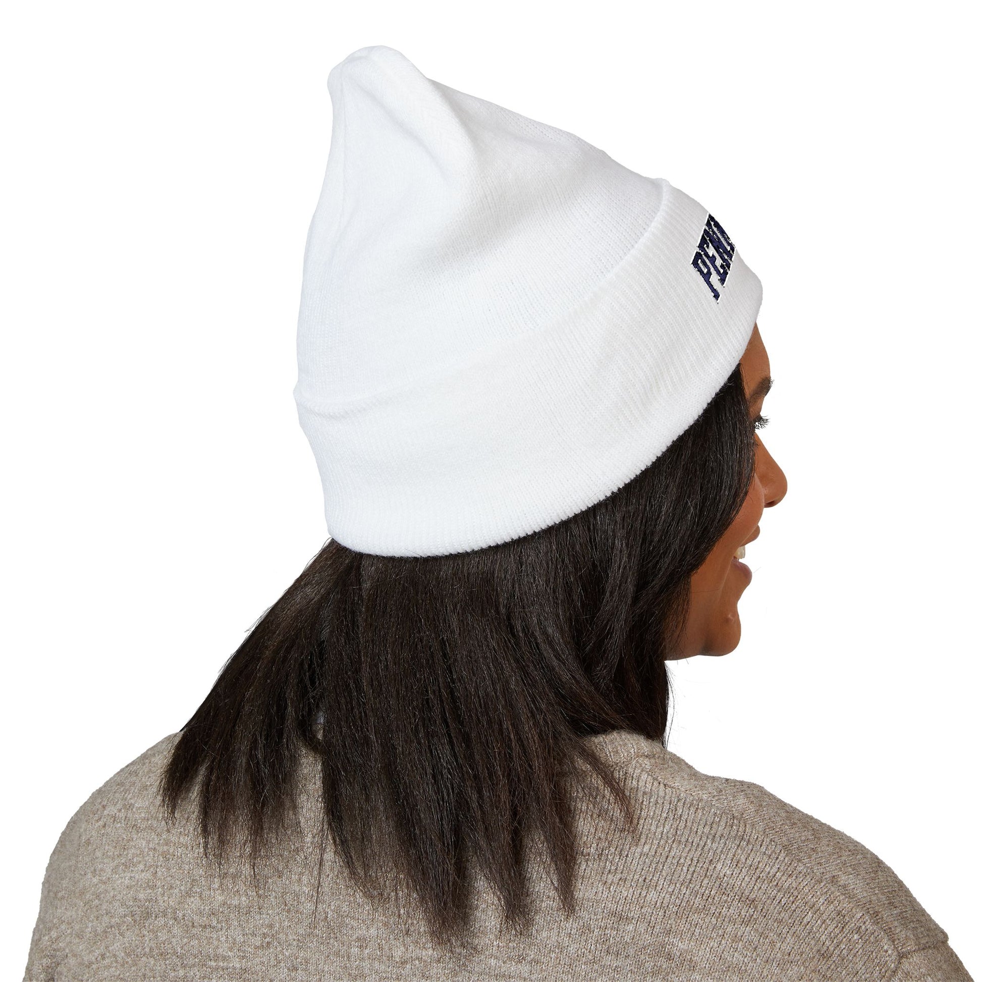 Person wearing a white beanie with a brand logo on a white background