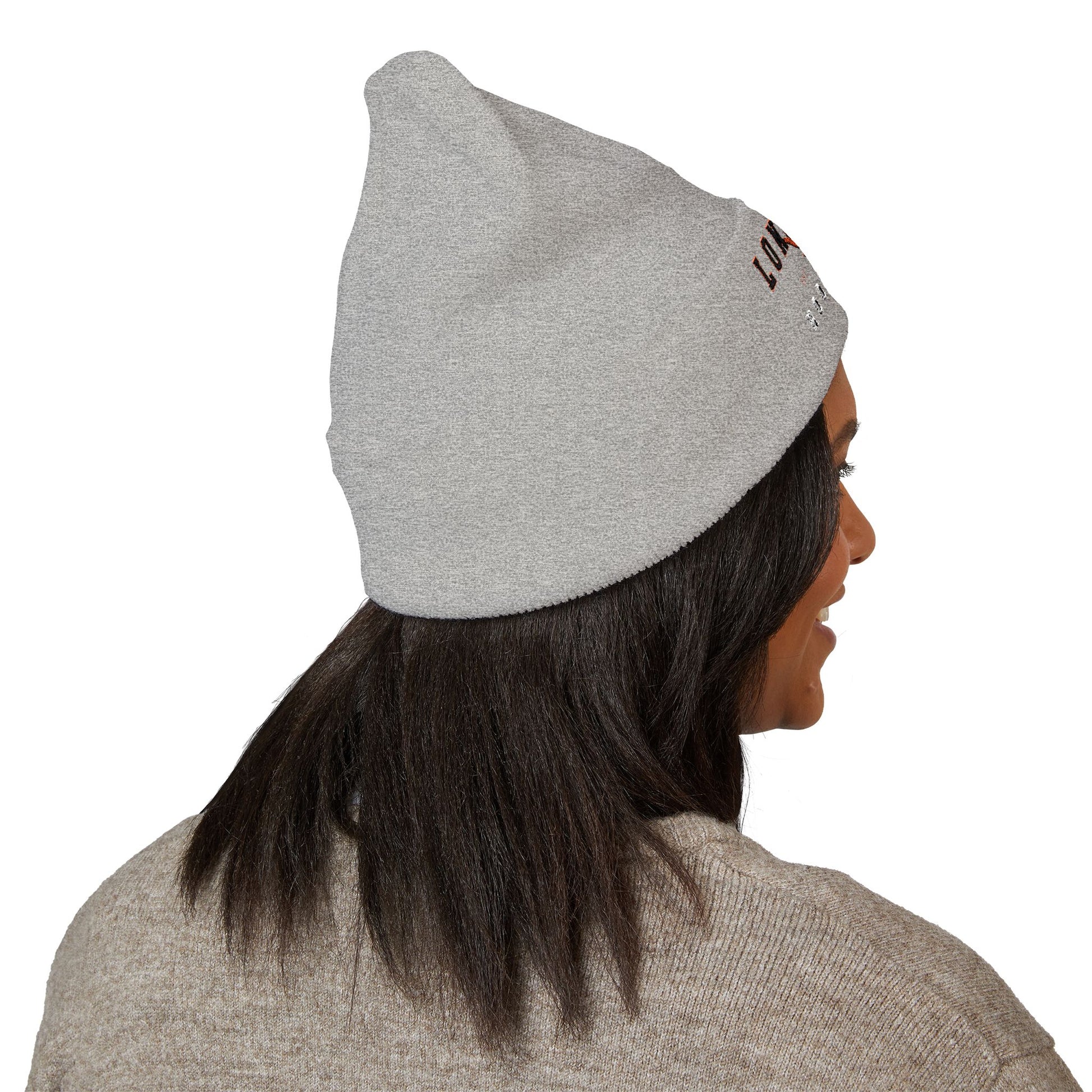 Person wearing a gray beanie with a brand logo on a white background with texas longs horns hook em logo